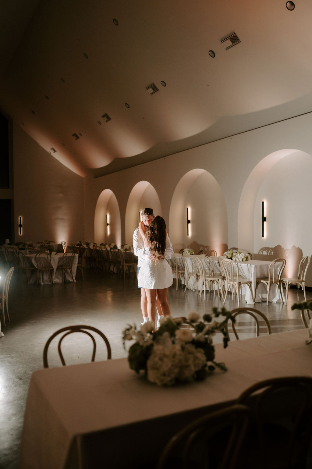 A bride and groom sharing a last dance before the end of their wedding day.