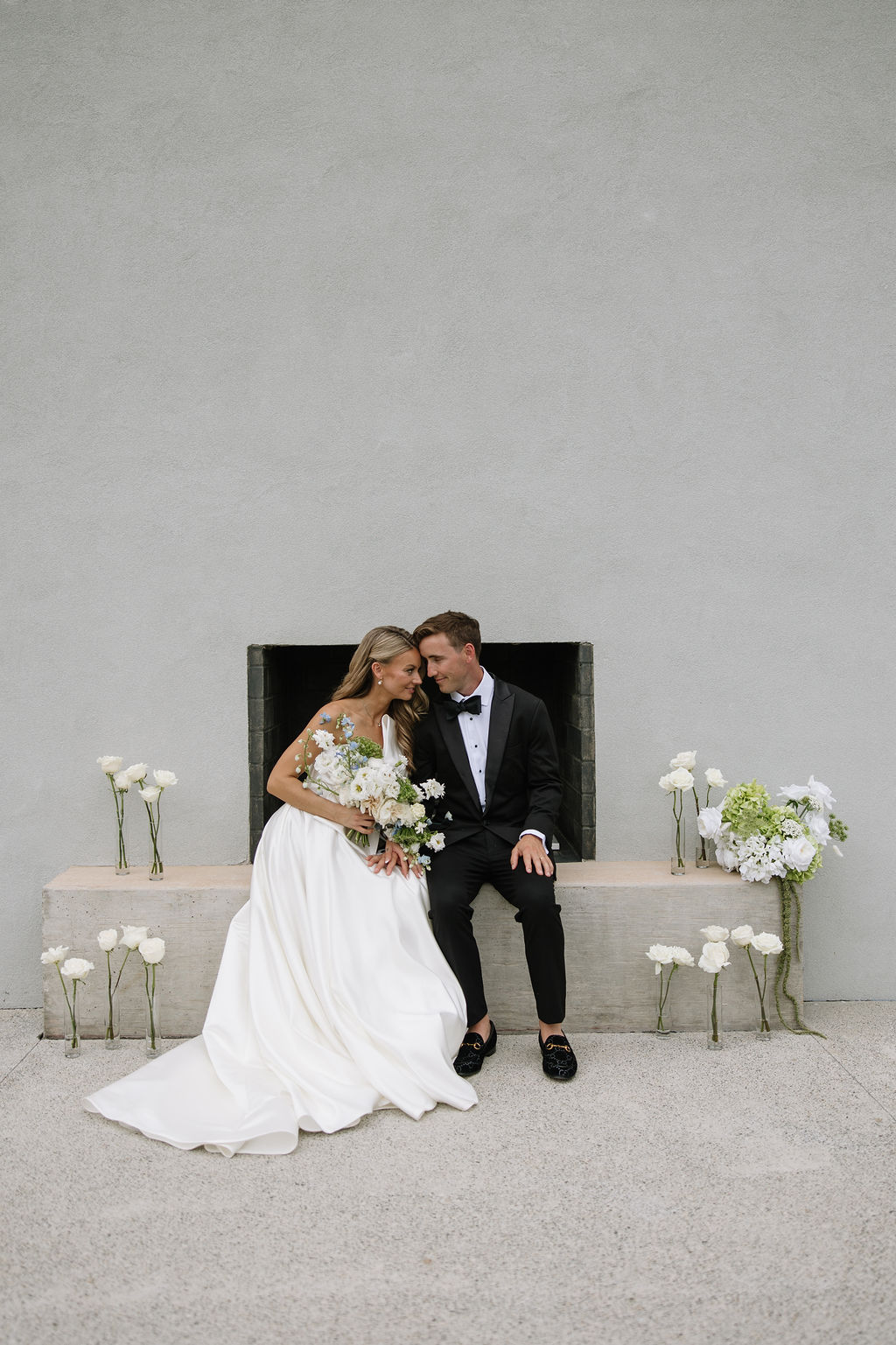 Bride and Groom Portraits at an outdoor fireplace.