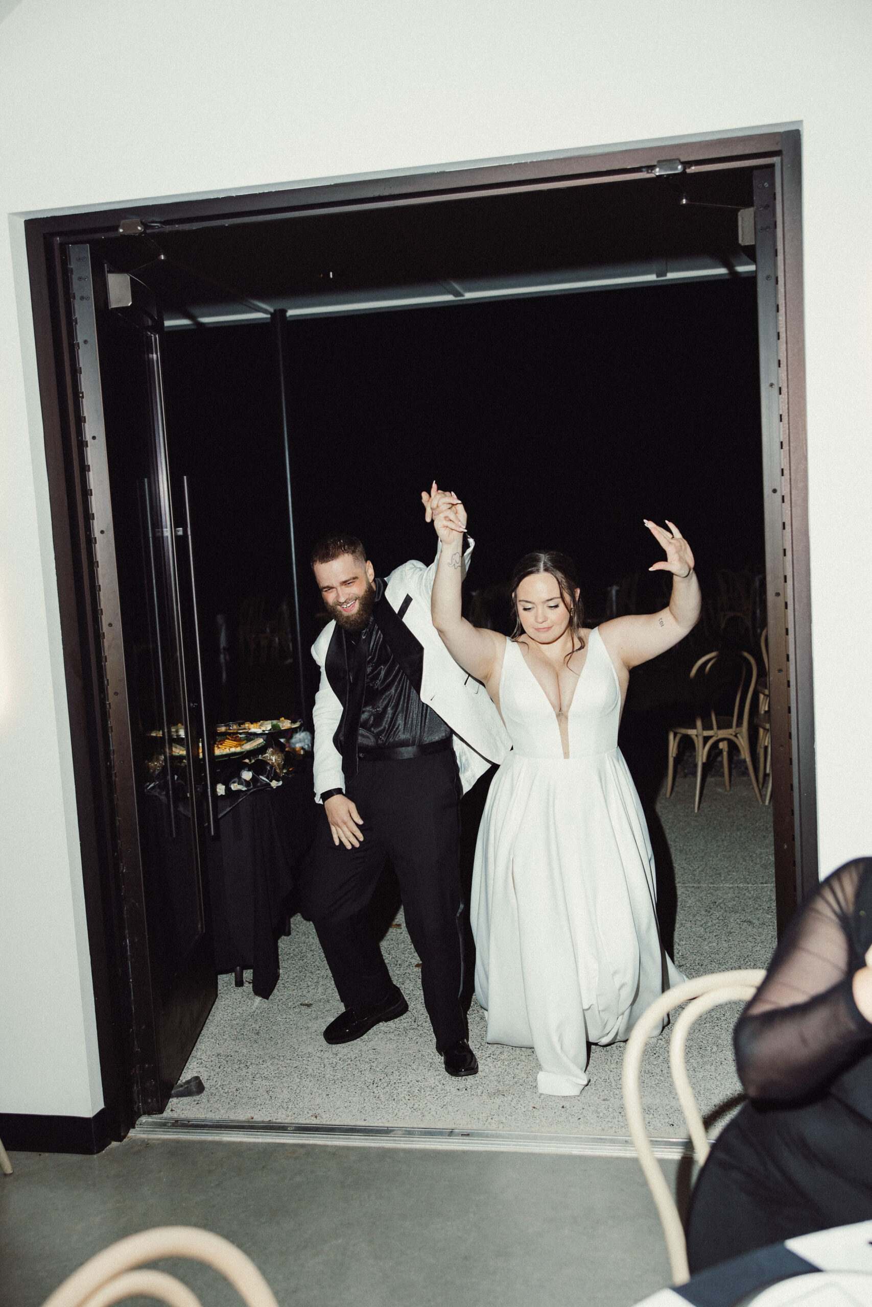 A bride and groom make an electric entrance into their reception.