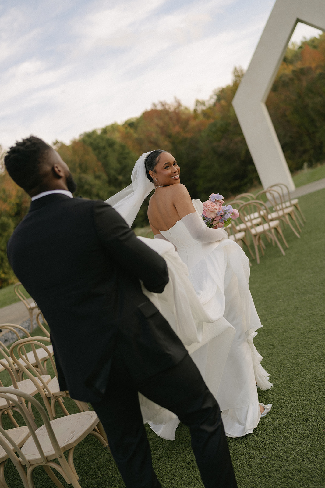 A bride and groom walking together for golden hour portraits.